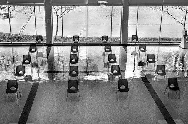 Plastic chairs, absent of students, staff and faculty, sit lined up inside the student center at South Campus, which offers localized services to students.