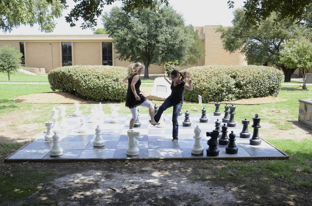Annabel+Mahon+and+Mia+Wilson+dance+during+a+game+of+chess+on+NE+Campu.+Many+students+spent+time+outside+enjoying+the+warm+weather+between+their+classes+on+the+first+day+of+school+Aug.+27.%0D%0APhoto+by+David+Reid%2FThe+Collegian