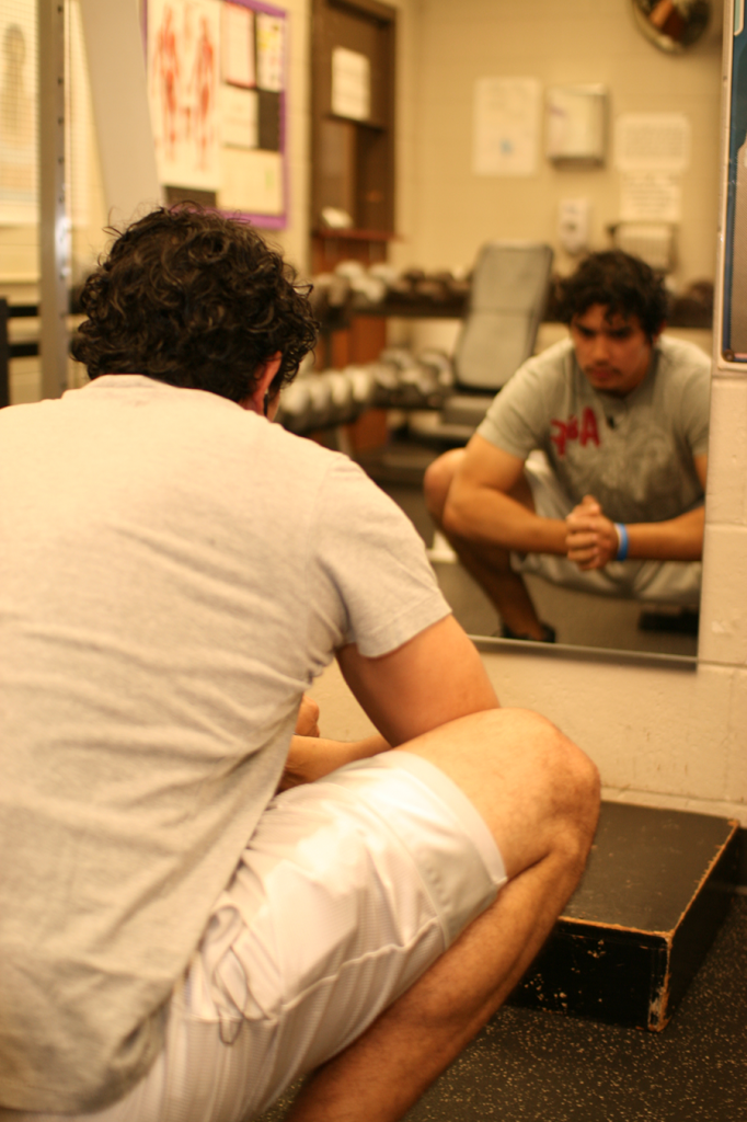 Ben Hernandez does stretches before he begins a work out in the NE Campus weight room.
Casey Holder/The Collegian