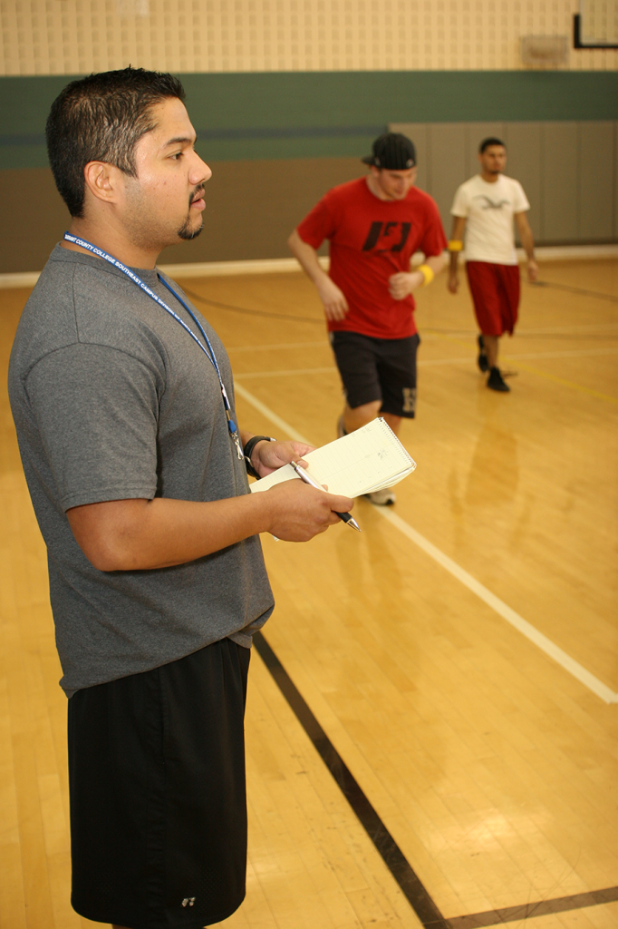 SE Campus intramural coordinator Danny Aguirre keeps score in a game of ultimate Frisbee. The number of students joining intramural sports has risen since Aguirre became coordinator. 
Casey Holder/The Collegian