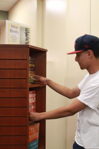 Joseph Gabaldon checks the new books at TR Campus library. Librarians encourage students to read more between classes. Haylie Jones/The Collegian