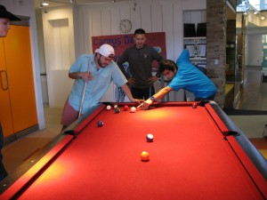 David Calzadillas, Edgar Hernandez and Gerardo Vega play a game of pool with friends in the Idea Store on TR Campus during the Service Fair Feb. 19.  Photo by Kirsten Mahon/The Collegian