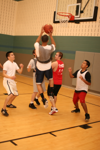 Students in recreational sports on SE Campus attempt to keep Roosevelt Powell from scoring two points in a small scrimmage. Casey Holder/The Collegian