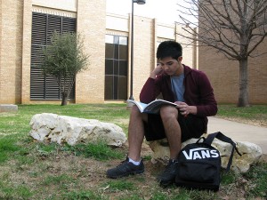 Some students like Fernando Castaneda find it relaxing to study on the rock path between the Science East and West buildings on NE Campus. Georgia Phillips/The Collegian