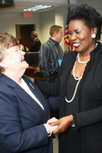 TCC’s director of grant development Jacqueline Maki, left, shakes hands with newly appointed Chancellor Erma Johnson Hadley after the board meeting March 10. Casey Holder/The Collegian