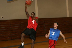 Andre Robinson, at left, finishes a layup during a South Campus intramural basketball game March 11. One game caused controversy when the winning basket occurred after the buzzer.Corban La Fon/The Collegian