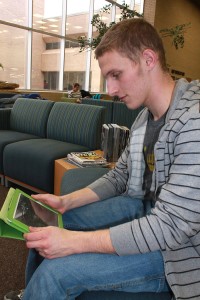 NW Campus student Samuel Cook reads his Kindle. Students have electronic access to all of the campus libraries’ resources.Haylie Jones/The Collegian