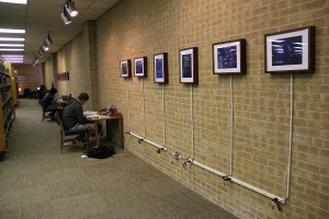 A student connects his laptop to one of three exhibition display areas in the J. Ardis Bell Library on NE Campus. Two areas downstairs and one area in main lobby will feature digital artwork submissions from students, faculty and staff. Photo by Zach Estrada/The Collegian 