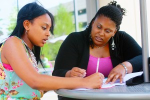 Faith Alexander and her mother LaTesha Alexander do homework outside of TR Campus. LaTesha is one of many single mothers who attend TCC. Photo by Carrie Duke/The Collegian