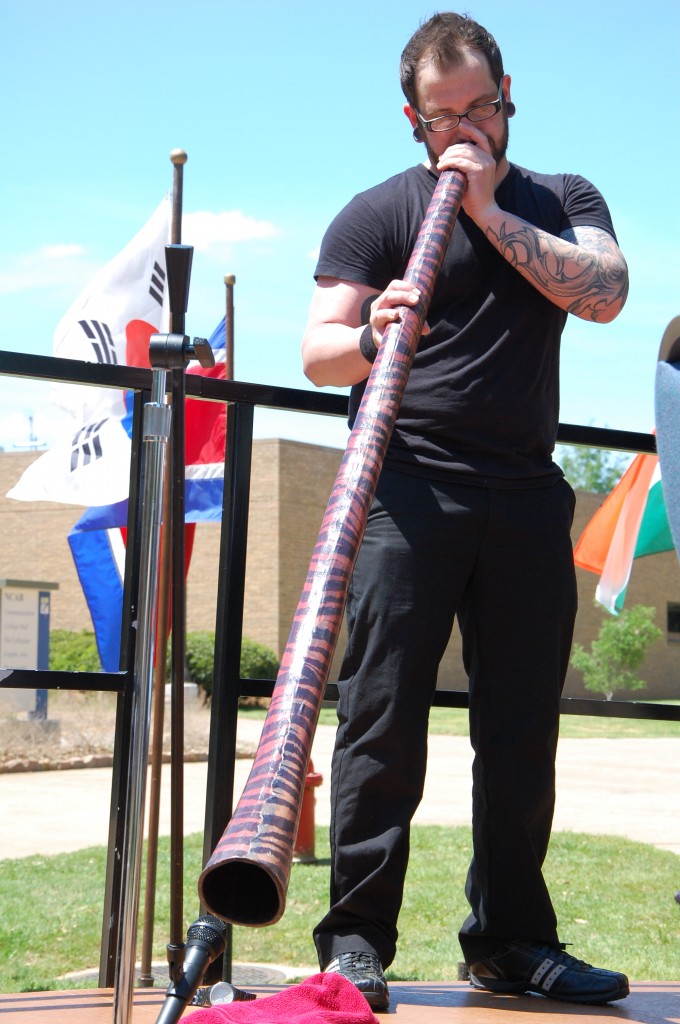 NE Campus music student Mike Foster performs with a didgeridoo, an Australian instrument, at the festival. 
