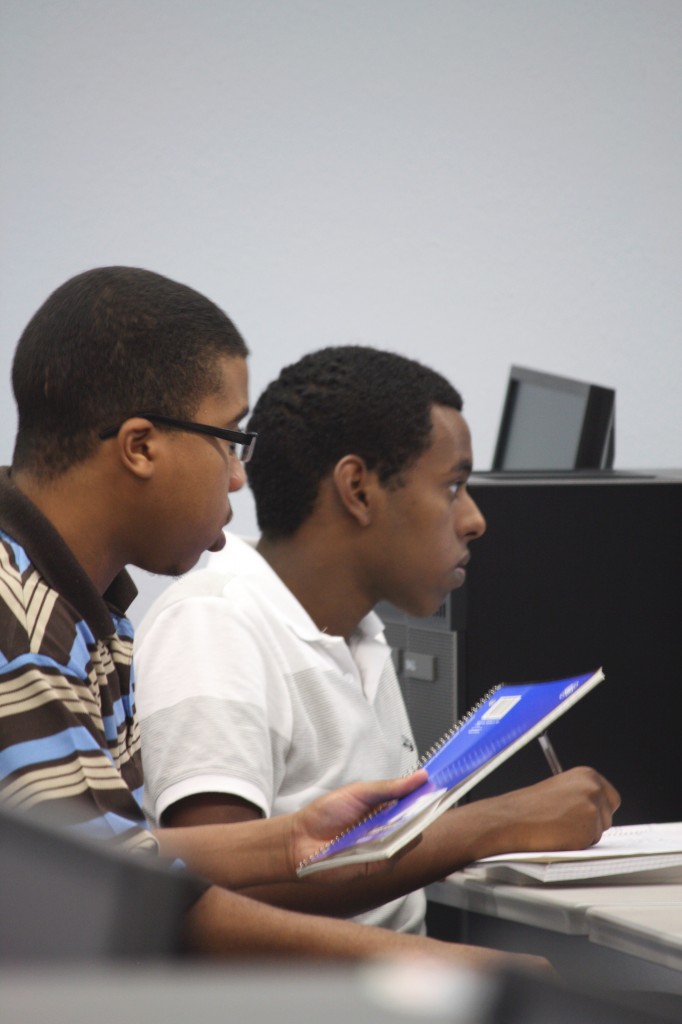 David Berhan (left) and Julian Donald listen and take notes during their writing class at the Haltom City Northeast Center. Photo by Kelsey Kimbrough/The Collegian