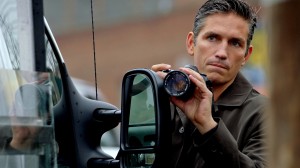Jim Caviezel takes pictures of his mark in an episode of Person of Interest. He doesn’t know if he’s tracking a killer or a victim. Photo courtesy ABC