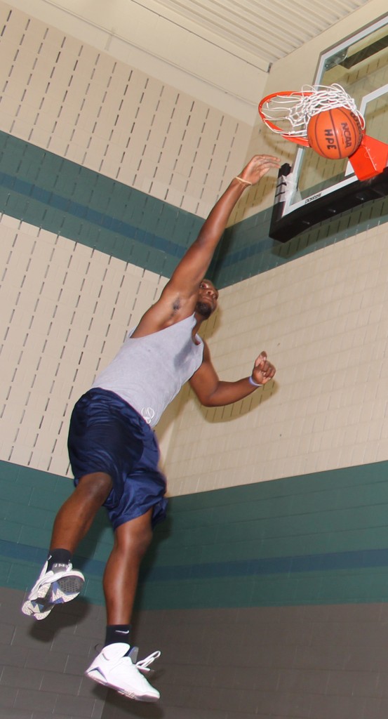 SE student Abiodua Adegoke does a reverse dunk in the gym. He plays in the gym every day after class.