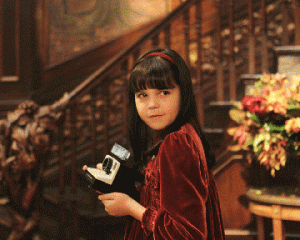 Sally Hirst (Bailee Madison) is haunted by small goblins that can’t handle bright lights in Don’t Be Afraid of the Dark. In this scene, she uses a camera with a large flash to defend herself. Photo courtesy Miramax Films