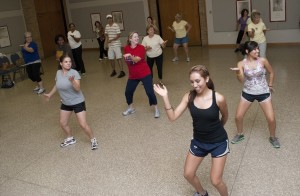 NE Campus students and faculty exercise to a Latin rhythm Monday afternoons during the free Zumba classes offered through the JPS Shape Up employee wellness program. David Reid/The Collegian