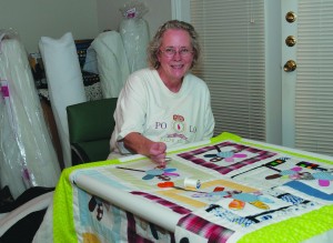 NW instructor Roxann Lindsay has sewn quilts since elementary school. She sewed a quilt and sent it to Quilts of Valor, an organization which pays tribute to men and women who’ve been injured in the military. Photo by Martina M. Treviño/The Collegian