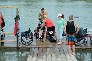 Volunteers assist Courtney Easley into the adaptive water ski.  Photo by Georgia Phillips/The Collegian