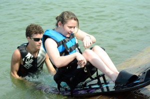 Courtney Easley sits in an adaptive water ski and is lowered into Marine Creek Lake with the help of a volunteer from Metroplex Adaptive Watersports during Lake Fest near NW Campus Sept. 7.  Photo by Georgia Phillips/The Collegian