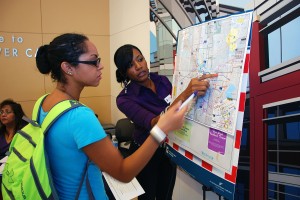 Lashelle Robinson of the Fort Worth Transportation Authority shows TR student Tamika Smikle the best route to take the bus.  Photo by Taurence Williams/The Collegian