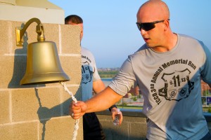 Firefighter Academy Cadet Jessie Ferguson rings the fire tower bell at the end of the run.  Photo by Yesenia Santillan/The Collegian
