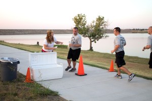 Volunteer Shelbee Linendoll passes out water at the halfway point of the run.  Photo by Yesenia Santillan/The Collegian