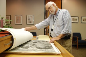College archivist Tom Kellam looks through old maps of northern Tarrant County. These and other historical items on NE Campus chronicle the district’s as well as the local community’s history.       Photos by Taurence Williams/The Collegian