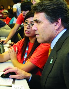 Gov. Rick Perry visits with Texas Woman’s University student Janet Gonzales as they walk through the Generation TX website Oct. 20.  Photo by Casey Holder/The Collegian