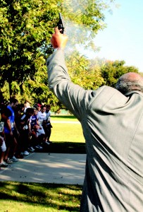 Dr. Ernest Thomas, South Campus president, fires a starter pistol to begin the Gobble Wobble Nov. 17. Participants donated five canned goods as an entry fee.  Photo by Casey Holder/The Collegian