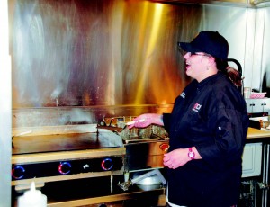 Celeste Neill prepares the grill in the NE 360º Food Court as the food services manager. Neill came to TCC in 2006 and uses her years of work in the food service industry.  Photo by Brian Koenig/The Collegian