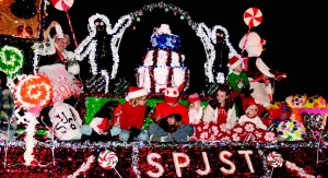 Children bundle up on the colorful SPJST float in the Parade of Lights Nov. 27. SPJST is a fraternal organization celebrating Czech heritage.  Photo by Casey Holder/The Collegian