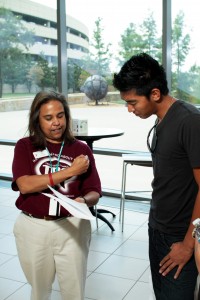 TR director of weekend college Letty Gallegos helps student John Owen make sense out of his class schedule.  Photo by Casey Holder/The Collegian