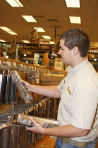 Scott Seibert, an employee at Cabela's, restocks merchandise during his shift. Seibert works in retail to help with his college expenses on NE Campus. He is one of many college students working in jobs on a temporary basis while in school.  Photo by Austin Williams/The Collegian