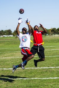 Miles Jones, left, from the Scoregasms and Kevin Perry, right, from TNT, go for the ball in a SE Campus flag football game.  Photo by Jason Floyd/The Collegian