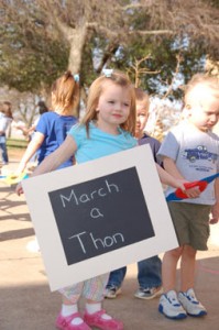 Shelby Peck, 2, lets NE Campus know that the tots from the TCC Children’s Center are on a mission while collecting more than $500 for charity.  Photo by Sarah McVean/The Collegian
