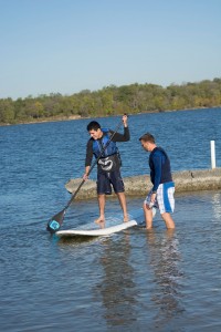 Joshua Tarbay shows student Luis Acosta how to properly use the paddleboard.  Photo by Jason Floyd/The Collegian
