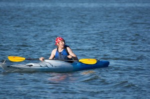 NW student Brian Dames sports a pirate bandana and eyepatch while taking on the challenge of kayaking. Joshua Tarbay said when there’s no or low wind on the lake, kayaks and paddleboards are an option to use instead of the sailboats.   Photo by Jason Floyd/The Collegian