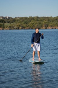 NW physical education instructor Joshua Tarbay demonstrates how to use the new paddle boards, which were a recent addition to the sailing courses in Marine Creek Reservoir.  Photo by Jason Floyd/The Collegian