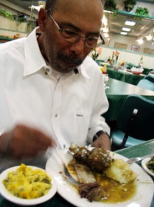 Dad enjoys a heaping plate of food at John Carter’s Place last week. John Carter’s is located on East Lancaster in Fort Worth.  André Green/The Collegian