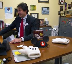 Jason Floyd/The Collegian  A copy of Inside the Magic Kingdom, along with Mickey ears and gloves, sits on Bryan Stewart’s desk on TR Campus, which operates on a Disney-inspired business model. Every new full-time employee is given a copy of the book when he or she is hired.
