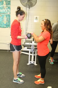 Haylie Jones/The Collegian  Above: NE student Elizabeth Martinez gets assistance from NE student Brittany White in the free weight room at the NE gym. Right: John Hurd lifts weights on South Campus. 