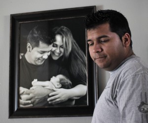 Ron T. Ennis/Fort Worth Star-Telegram/MCT  Erick Muñoz stands in front of a photo of him and his wife.