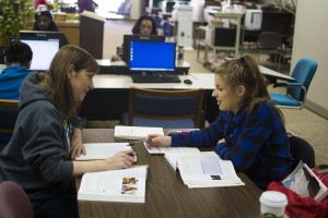 Jason Floyd/The Collegian  NE student Rita Kendall, left, receives assistance from Haley Kish, who serves as an SI for a sociology class on NE Campus. Instructors hire SIs from among their best students. SIs sit in on classes, take notes, hold study sessions and prepare students for tests. 