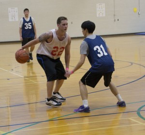 Jason Floyd/The Collegian  Brett Lewis, a member of the Buckets, gets ready to pass Thao Nguyen during the NE Campus basketball tournament Feb. 21. 