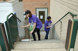 Georgia Phillips/The Collegian  Volunteers paint at the YWCA, one of many projects for them to choose from at the TR Campus Day of Service March 22. Other projects included pulling weeds, watering plants, picking up trash along the Trinity River, checking expiration dates and organizing donations at the Tarrant Area Food Bank among others.