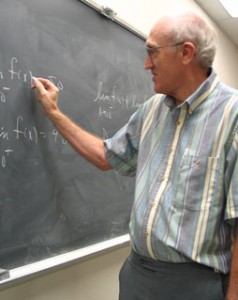 David Price, associate professor of math on SE Campus, uses the chalkboard to explain math equations. Price was named one of the top 15 college educators in Texas by the Minnie Stevens Piper Foundation.  Photo by Rachel Hudson/The Collegian