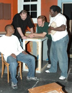 Living in a group home, three mentally challenged men are visited by a social worker in The Boys Next Door, playing next weekend on NW Campus. The players are, seated, Tony Boone, who plays the social worker, and Tom Wood, Joe Panuska and Ecko Wilson, who play the home residents.  Photo by Martina Treviño/The Collegian