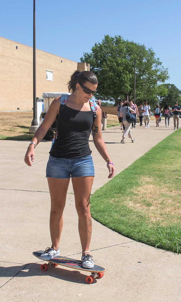 NE student Mary Parrett swiftly makes her way across campus on Aug. 25. Students said goodbye to summer as they began the fall semester. Parking lots were full, and bookstore lines were long.  Katelyn Townsend/The Collegian.
