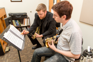 NE music associate professor Jerry Ringe gives guidance to NE student Mike Tice during a saxophone lesson. New degree plans will offer more music credit hours to students. Eric Rebosio/The Collegian