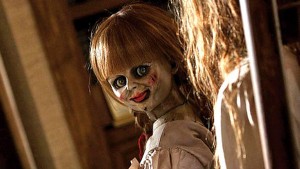Annabelle sits and terrorizes the Gordon family from her place on a shelf in John R. Leonetti’s new horror film Annabelle. Photo courtesy New Line Cinema