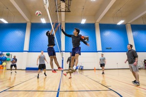 Brothers Luis and Daniel Villanueva play at the net on opposing teams during NE Campus’ intramural volleyball event Nov. 14. Eric Rebosio/The Collegian